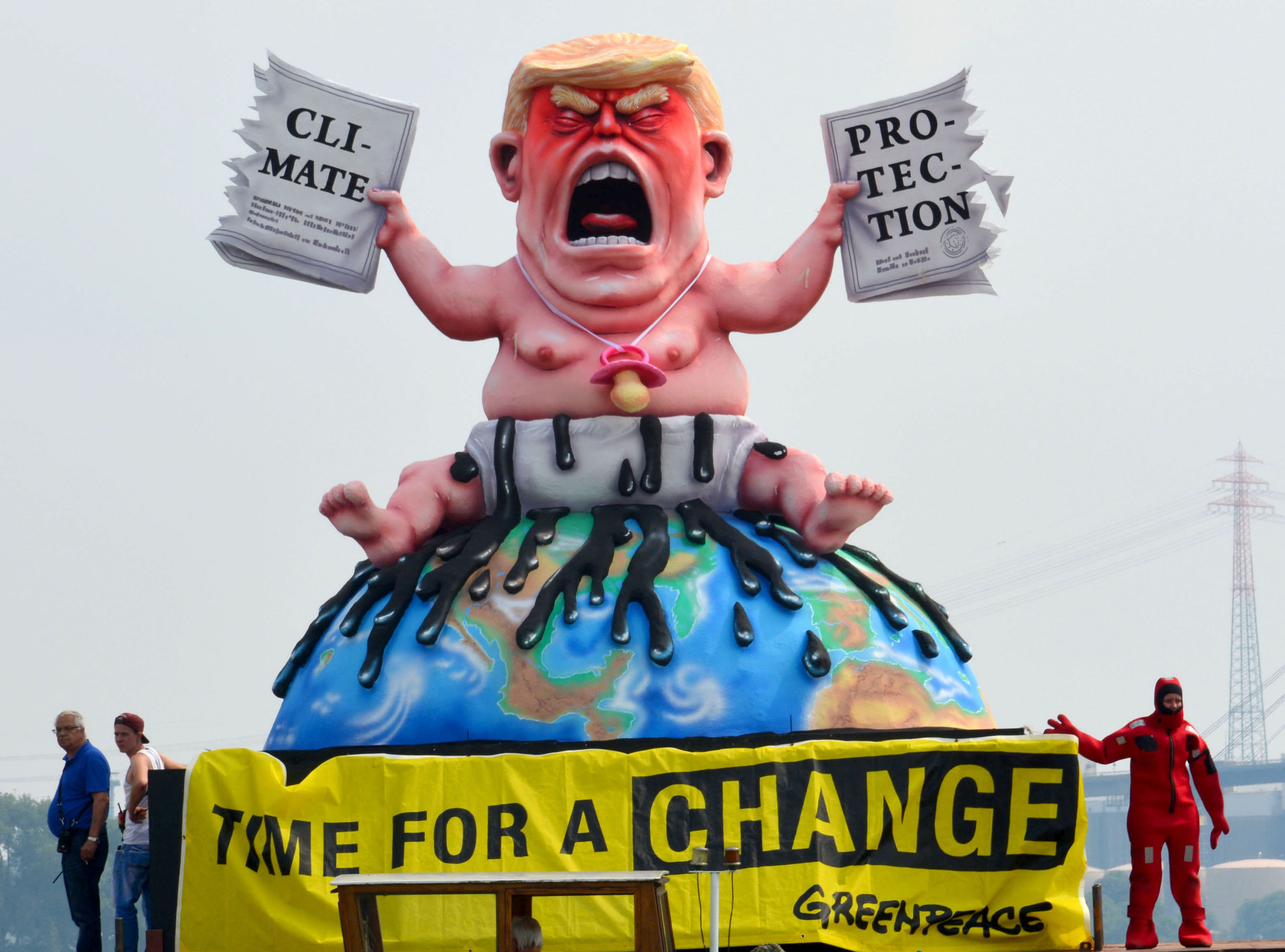 Sculpture of Donald Trump ripping up the Paris climate agreement.