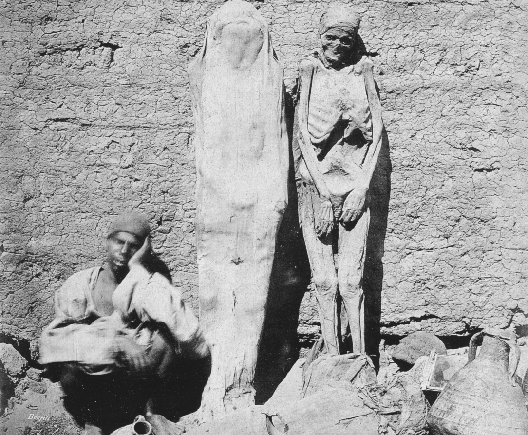 An photograph captured by Felix Bonfils of a street vendor selling mummies and other Egyptian artifacts to tourists, 1875.