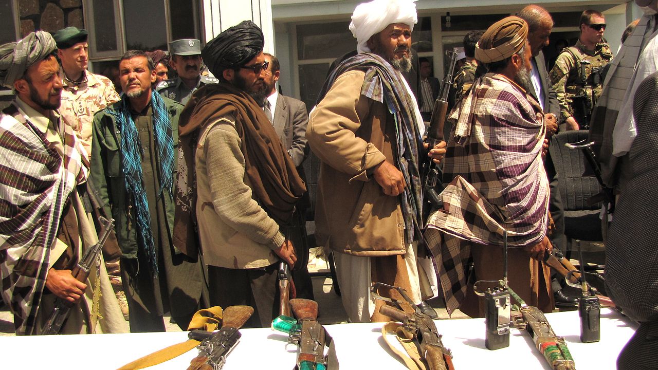 A group of former Taliban fighters handover their rifles to the government of Afghanistan during a reintegration ceremony, 2012.