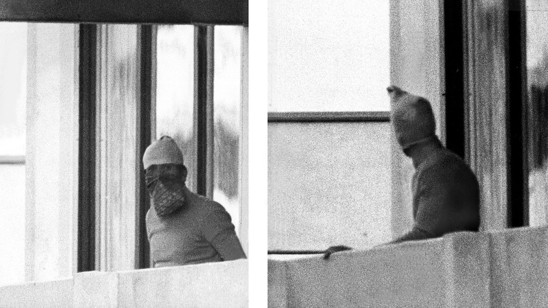 Members of Black September on the balcony of the Olympic village building.