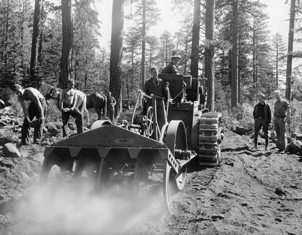 The CCC boys operating tractor and rooter.