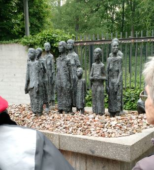 A memorial to Holocaust victims in front of a Jewish cemetery.