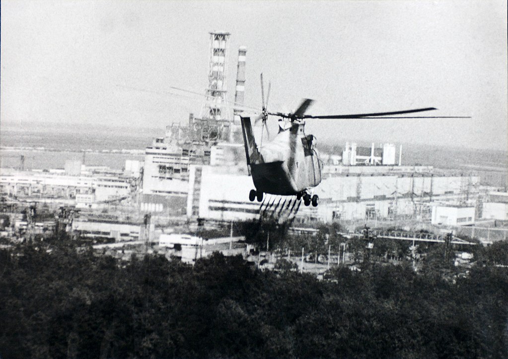 A helicopter sprays a decontamination liquid near the Chernobyl reactor.
