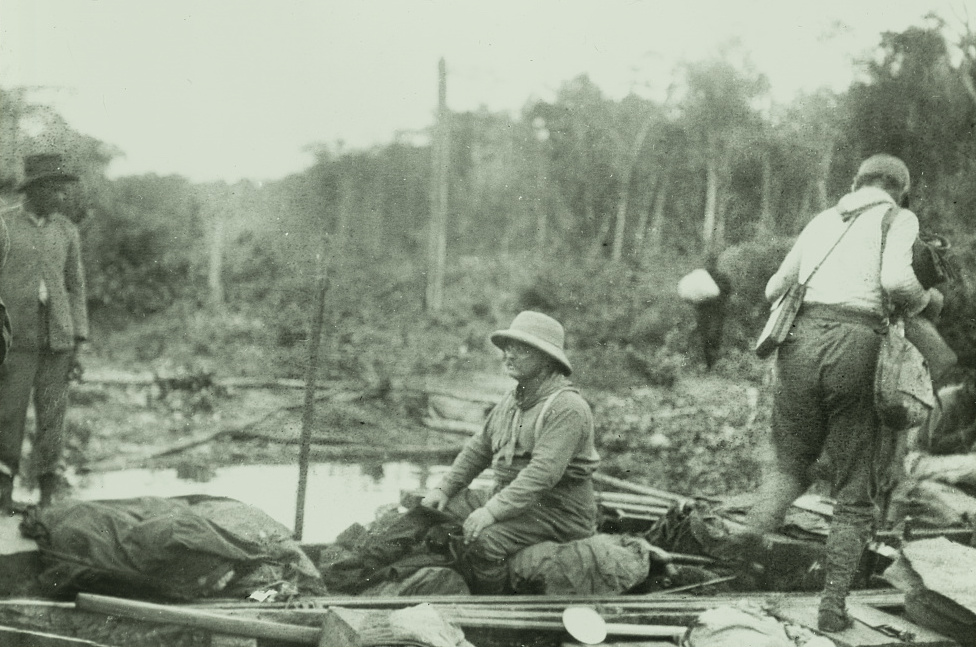 Theodore Roosevelt sitting in a boat during the 1913-1914 Rondo-Roosevelt Scientific Expedition in the Amazon.