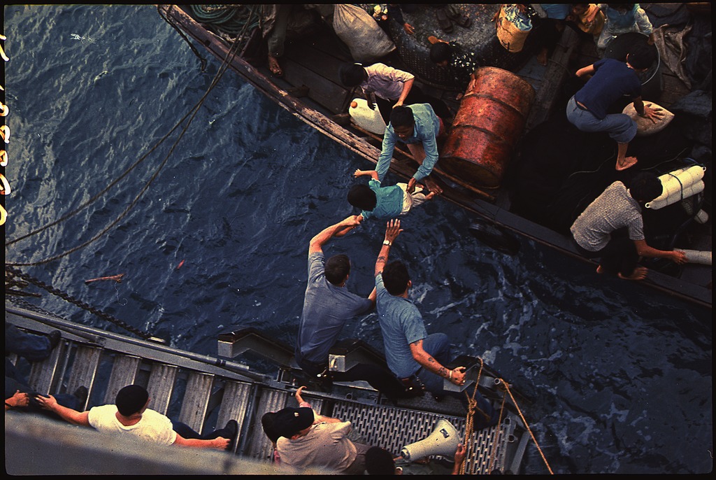 Crew on the USS Durham help Vietnamese refugees.