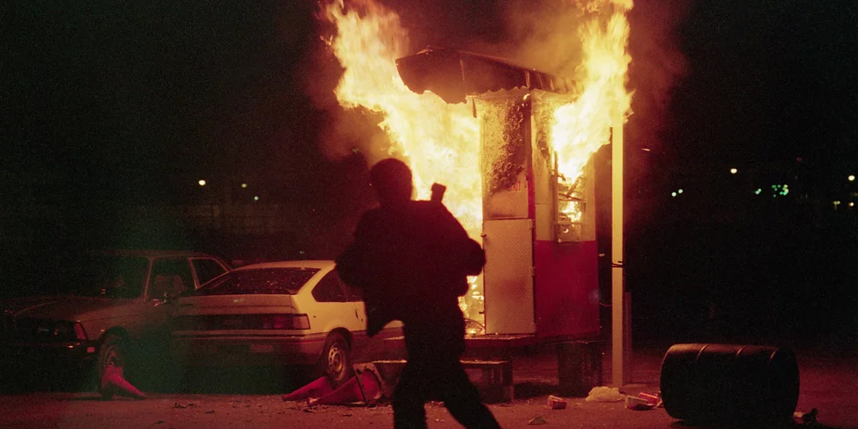 man running near a burning building - Photo by Bettmann Collection/Getty Images