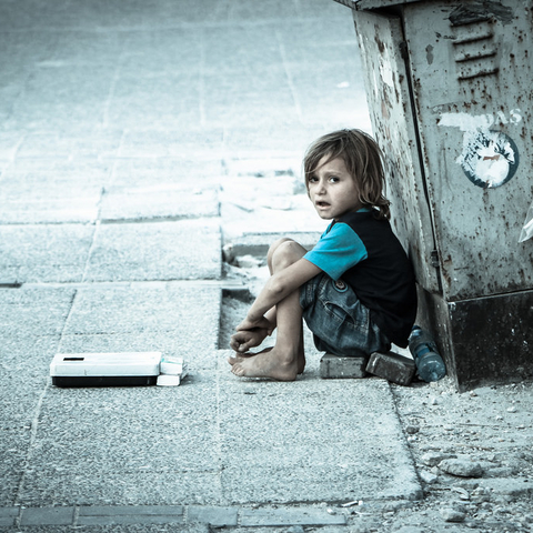 A Syrian boy waiting for assistance in 2014.