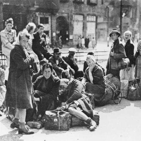 Refugees in 1945 Berlin awaiting transportation.