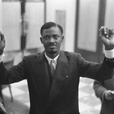 Future Prime Minister Patrice Lumumba showing the injuries to his wrists.