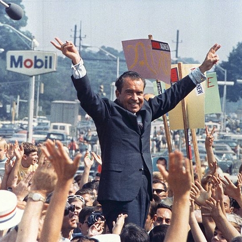 Richard Nixon giving his 'victory' sign at a 1968 campaign rally in Pennsylvania.