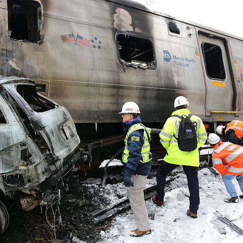 Workers survey the damage after a commuter train crashed into a passenger car near Valhalla, NY in 2015.