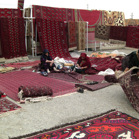 A Merchant selling carpets in Tolkuchka, Turkmenistan, 2008  
