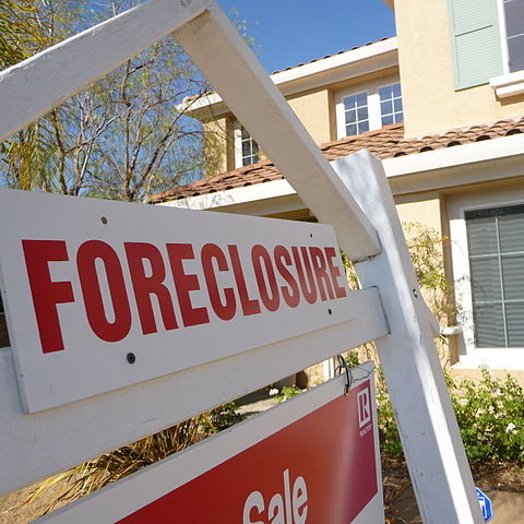 A foreclosure sign in front of a home 
