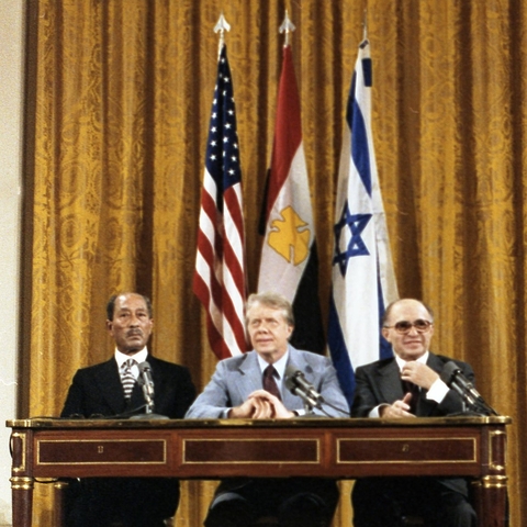 Egyptian Prime Minister Anwar Sadat, U.S. President Jimmy Carter, and Israeli Prime Minister Menachem Begin signing the Camp David Peace Accords on September 17, 1978.