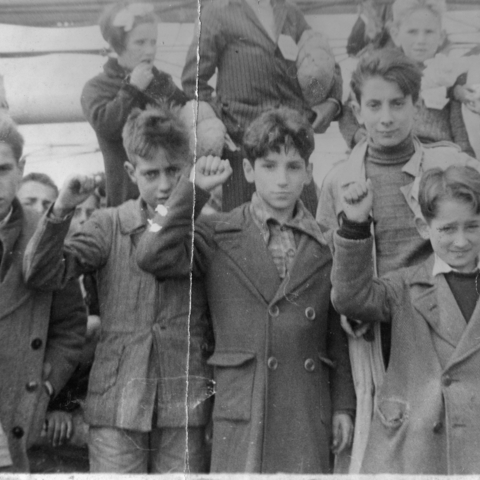 Children evacuated during the Spanish Civil War (1936-1939) giving the Republican salute.