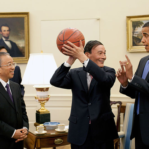 Chinese Vice Premier Wang Qishan holding a basketball President Obama gave him.
