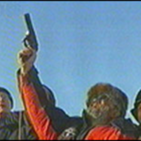 Famed Russian polar explorer Artur Chilingarov fires a pistol into the air to celebrate establishment of a new research station in 2003.