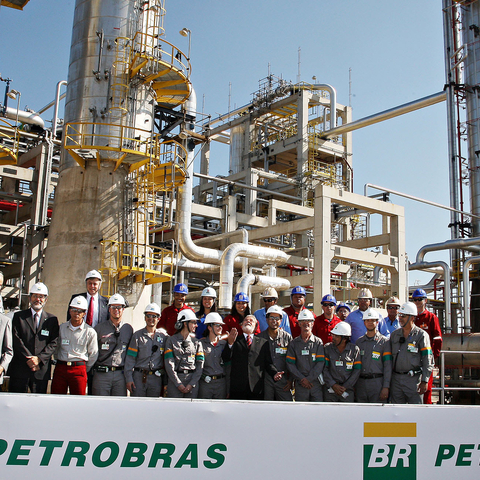 President Luiz Inácio Lula da Silva (center, looking up) poses with workers at a refinery of Petrobras, Brazil’s government-controlled oil company