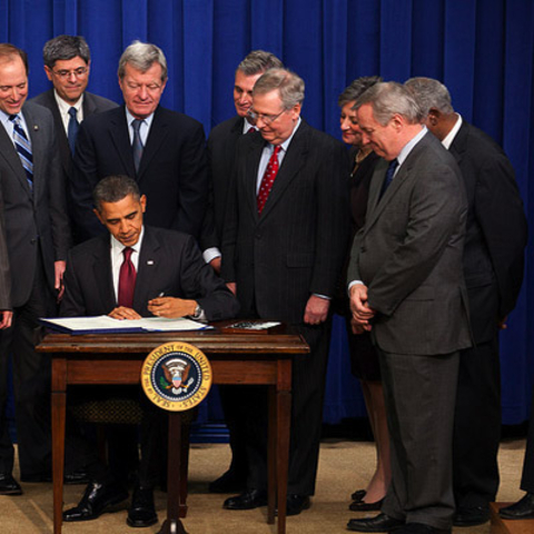 President Barack Obama signs the Tax Relief, Unemployment Insurance Reauthorization, and Job Creation Act of 2010 at the White House.