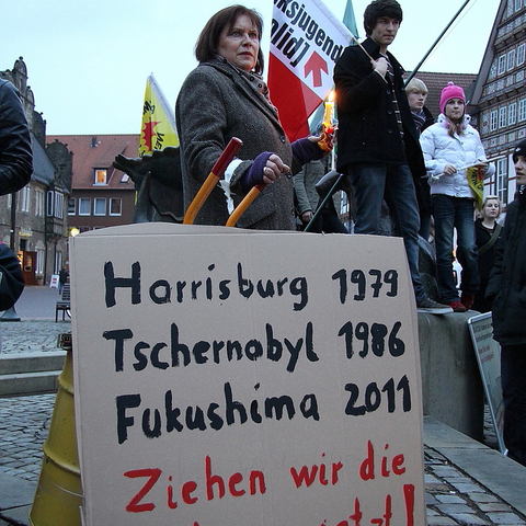 A sign at a March 2011 protest in Germany gives the dates of accidents at the Three Mile Island, Chernobyl, and Fukushima nuclear power plants and states: 'Now, let's draw the lessons.'