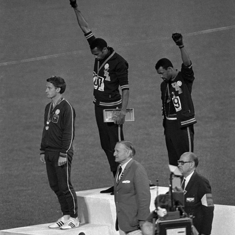 U.S. athletes Tommie Smith (gold) and John Carlos (bronze) raised fists during the playing of the U.S. national anthem.