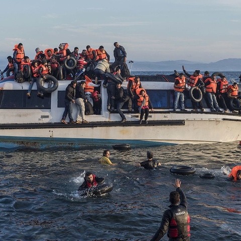Syrian and Iraqi refugees being rescued by Spanish volunteers off the coast of Greece.