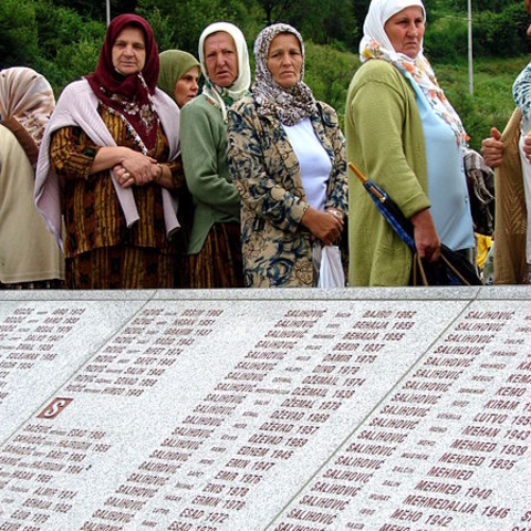 Women stand by a monument to victims of the 1995 Srebrenica massacre during a memorial ceremony in Potocari, Bosnia and Herzegovina, in July 2007.