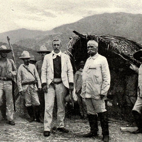 This photograph presents the Cuban general of rebel forces with a group of Cuban rebels and American General William Ludlow.