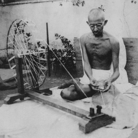 Mohandas K. Gandhi spinning yarn, late 1920s