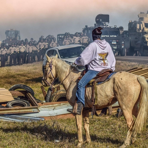 A protester at Standing Rock watches the police convene.