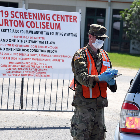 A National Guardsman assists with a drive through testing site for COVID-19 in Louisiana, 2020.