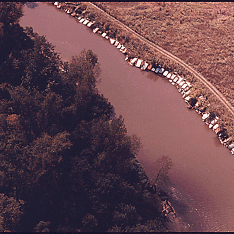 Aerial view of old cars secured along the banks of the Cuyahoga River.