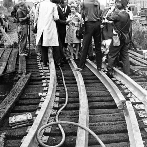 Mayor Carl Stokes holds a press conference on a charred railroad bridge in 1969.