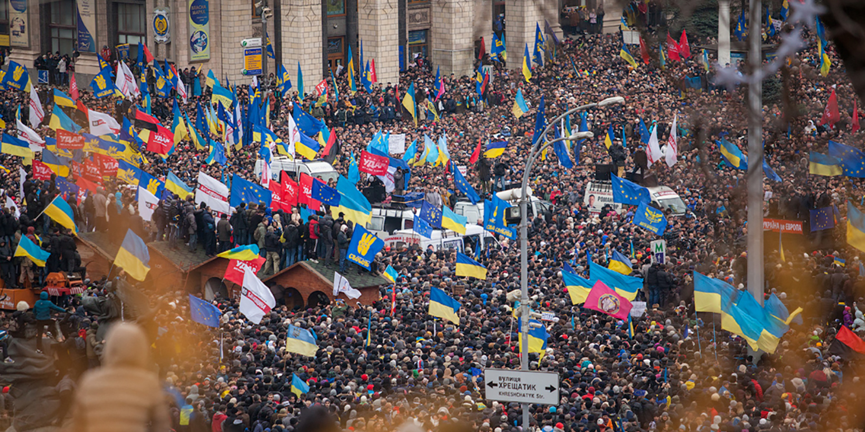 Crowds of people waving Ukrainian flags