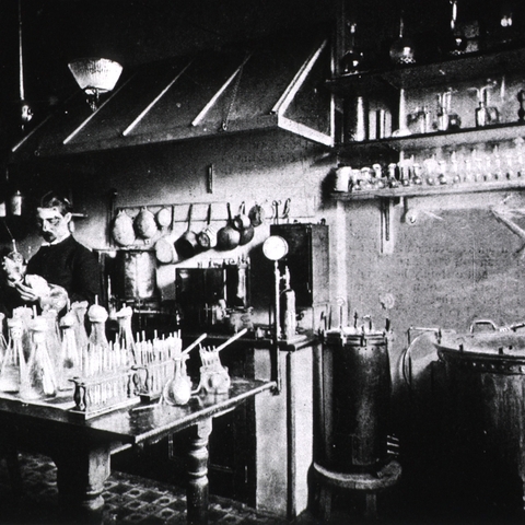 Laboratory worker in 1895 sterilizing chicken broth in autoclaves at the Pasteur Institute.