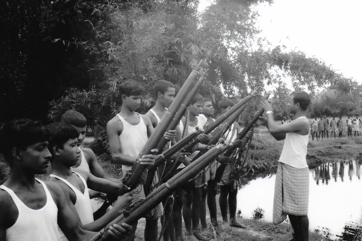 soldiers holding guns near a body of water