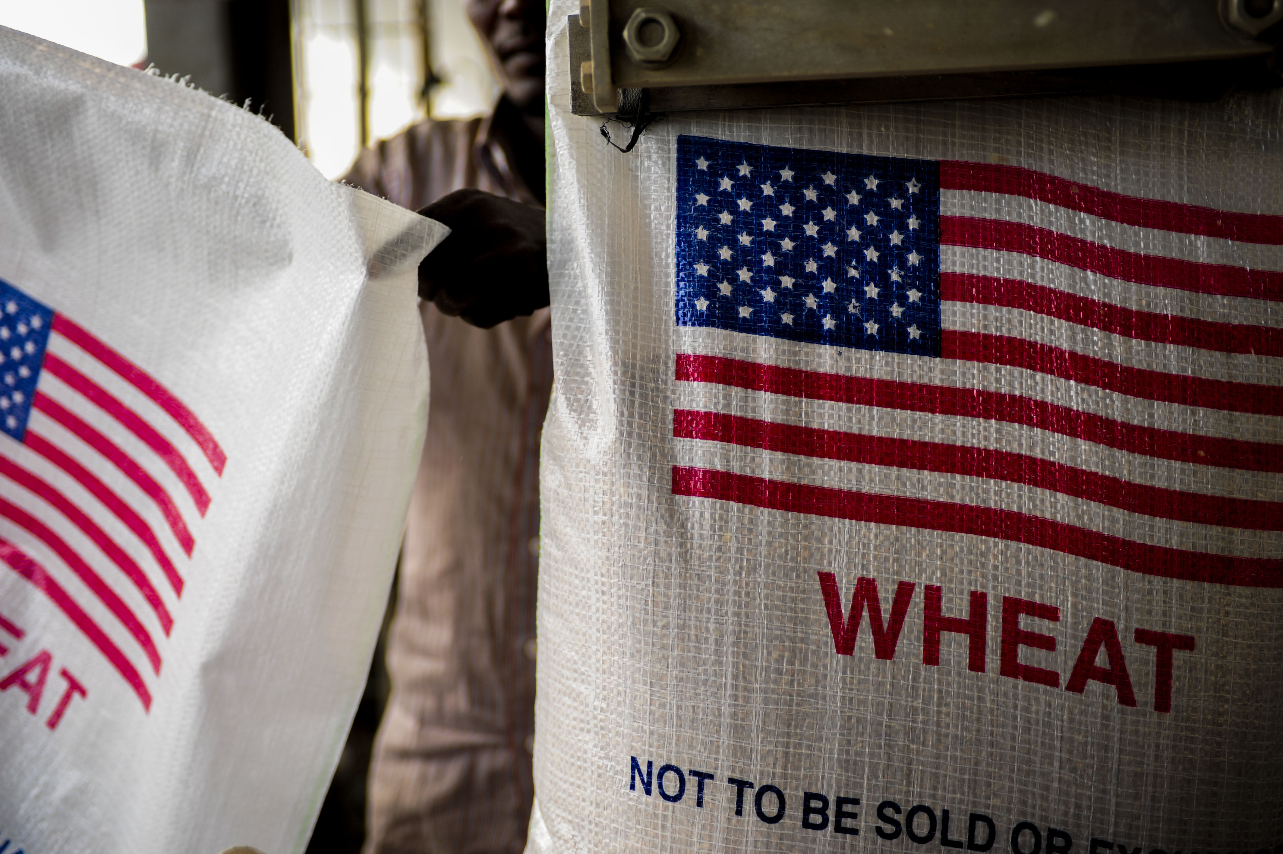 Djiboutian workers fill bags with wheat destined for Ethiopia, provided by the United States Agency for International Development (USAID), at the Port of Djibouti, Africa, Jan. 7, 2013. 