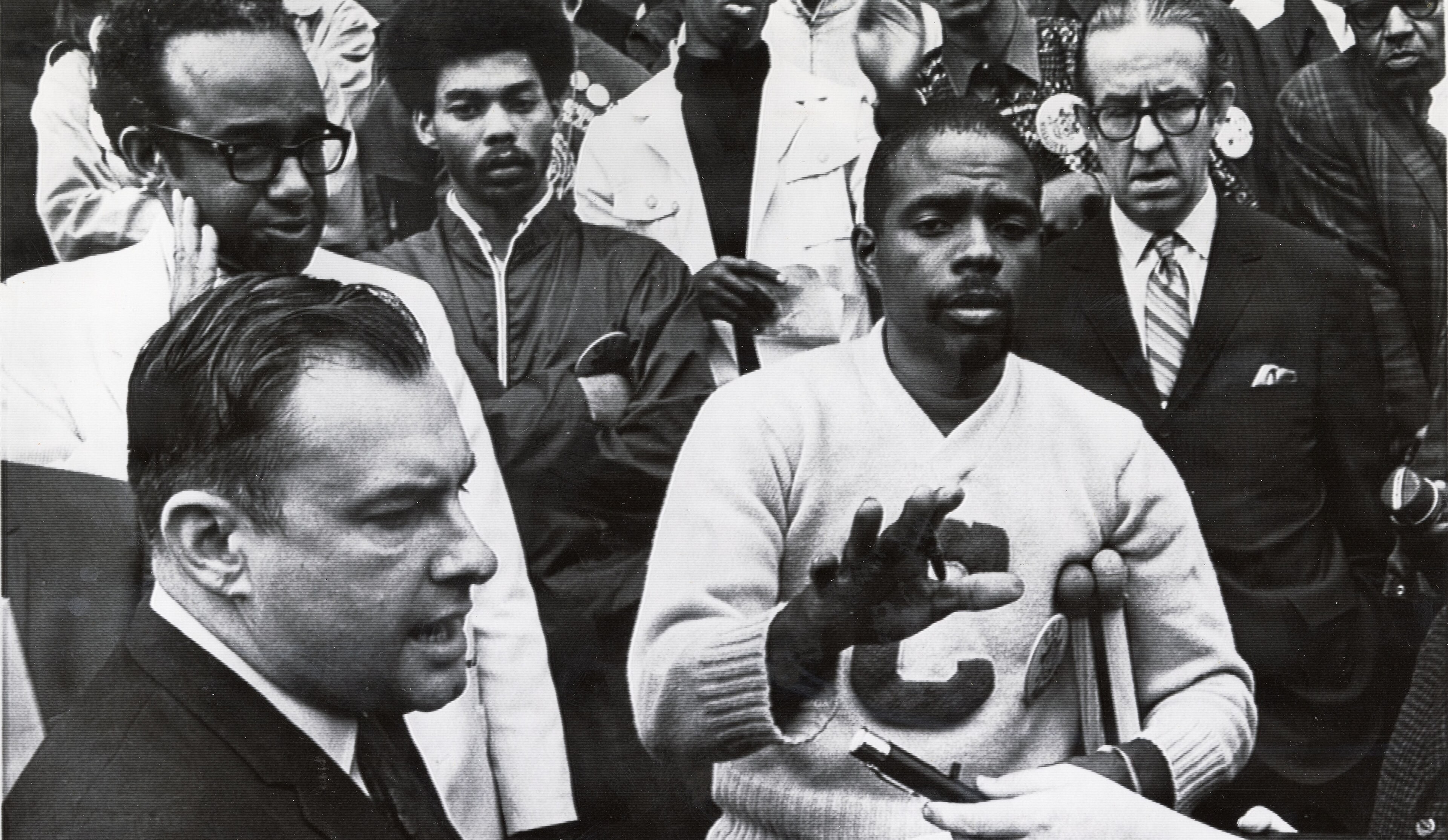 Ohio House Speaker Charles Kurfess, left, and Leonard Tate, center, hold up their hands after Kurfess made a statement to demands made by Tate on the steps of the state Capitol in Columbus. Tate, leading a large group of mostly Black demonstrators, presented four demands by the student body of Central State University, 1969.