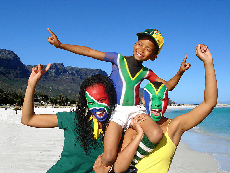 Soccer fans, painted in the colors of South Africa's flag, celebrate the coming of the 2010 FIFA World Cup to South Africa.