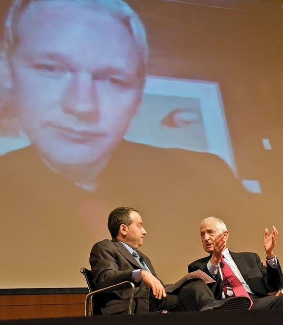A projection of WikiLeaks founder Julian Assange looms over author Micah Sifry (left) and activist Daniel Ellsberg during a video conference in June 2010.