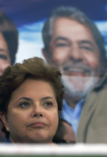 Brazil's President-elect Dilma Rousseff stands before an image of her mentor, President Luiz Inacio Lula da Silva (Lula).