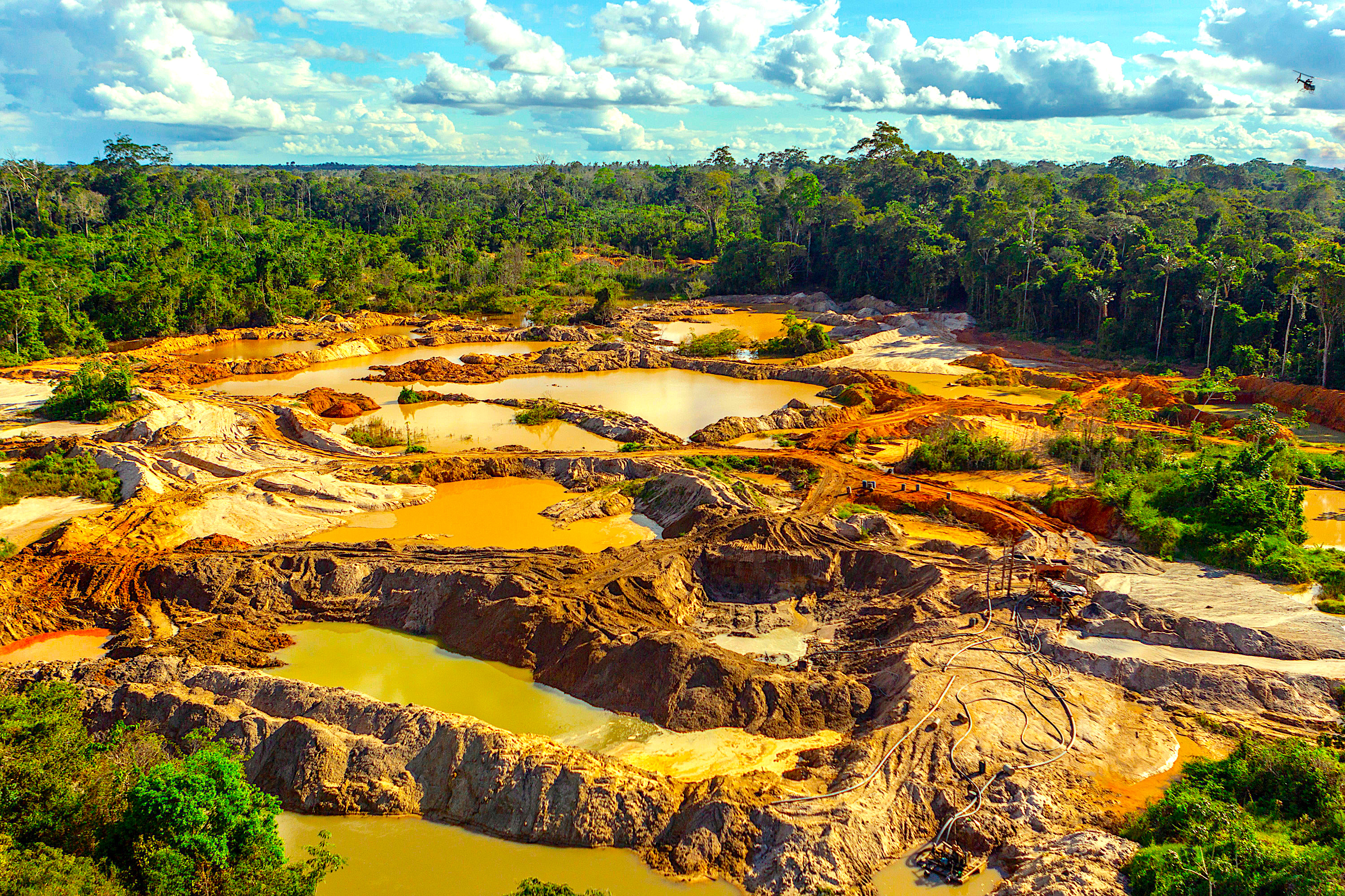 Rainforest scars from illegal mining and deforestation.