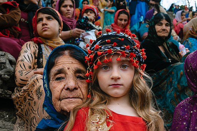 A Kurdish woman with her granddaughter at a 2017 Nowruz (Persian New Year) celebration.