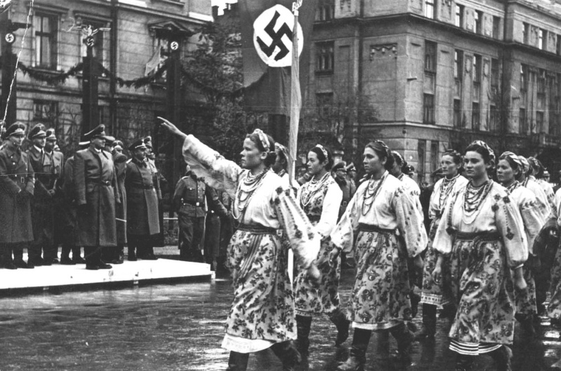 Women in Ivano-Frankivsk, a city in western Ukraine, salute Nazi officials, 1941. 