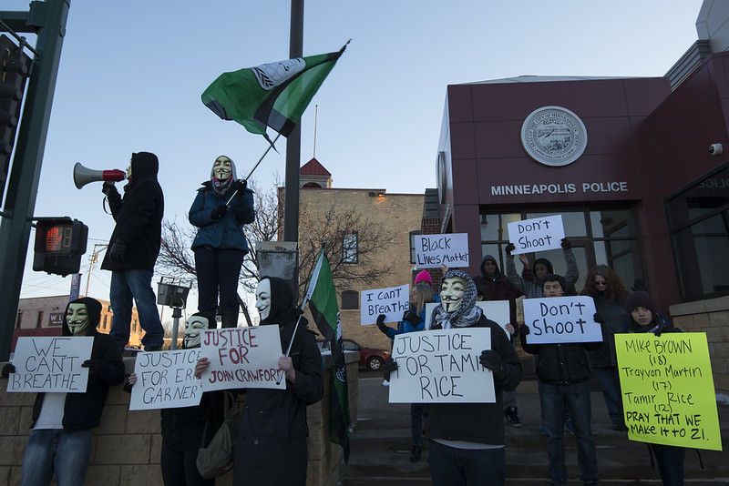 Protestors in Minneapolis hold signs demanding justice for the police killings of Tamir Rice and John Crawford, both of which occurred in Ohio.