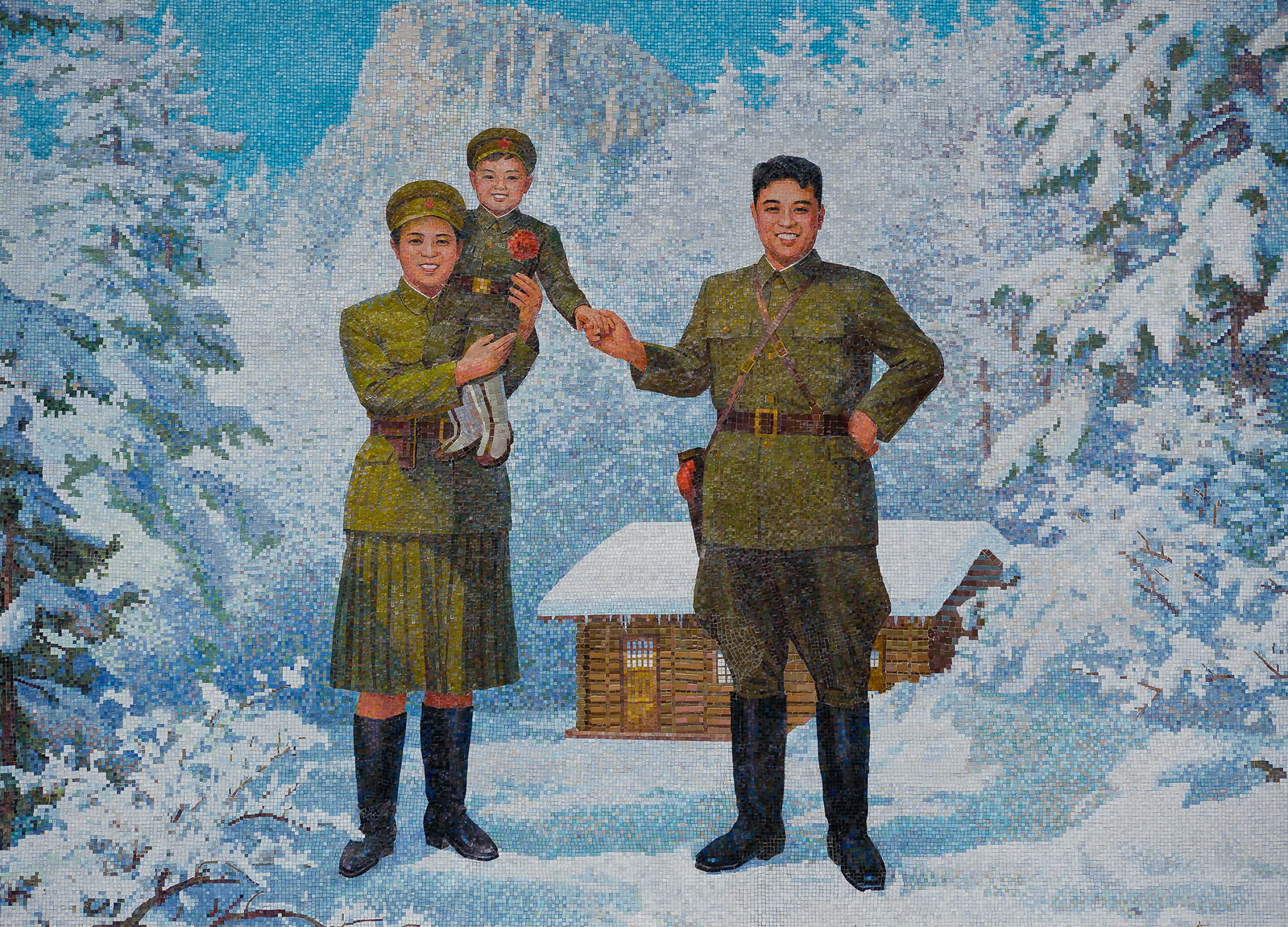 A public mosaic in North Korea of Kim Jong-Il in the arms of his mother Kim Jong-suk and his father Kim Il-sung.