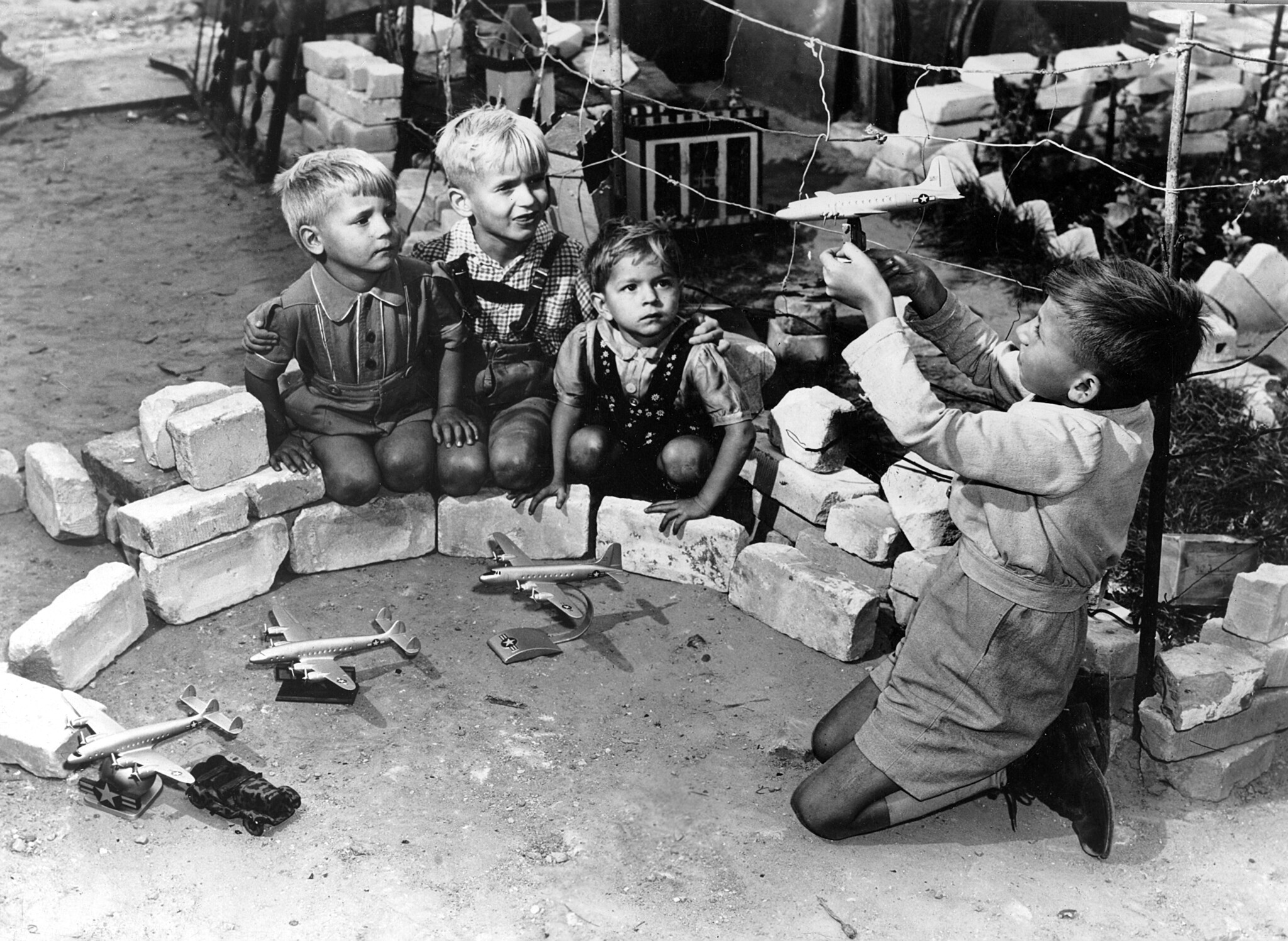 German children in Berlin playing with model U.S. airplanes during the Berlin Airlift.
