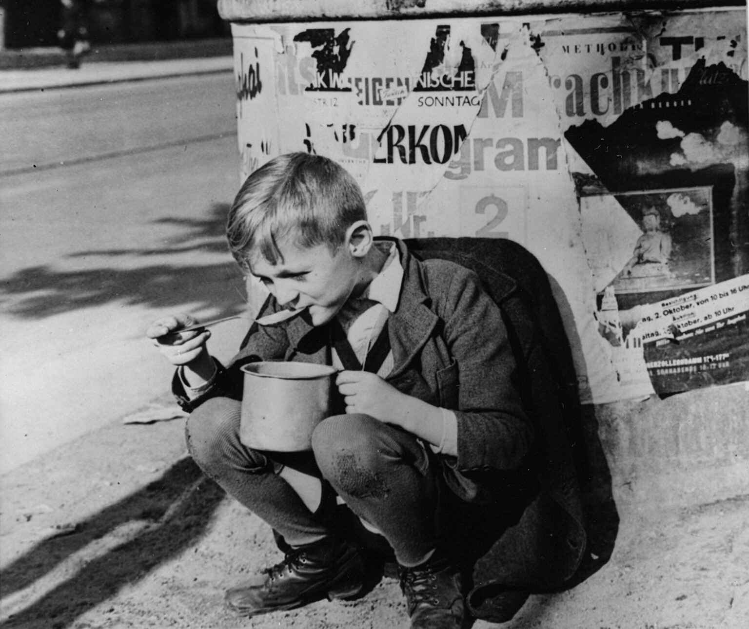 A German child in Berlin eats soup delivered by Western planes during the Berlin Airlift.