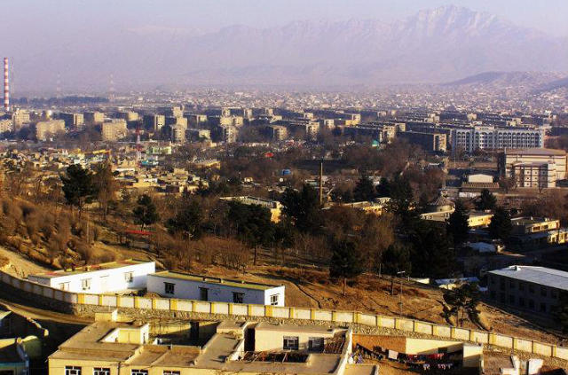 Prefabricated concrete residential complexes known as mikrorayons in Kabul with the Hindu Kush mountains in the background