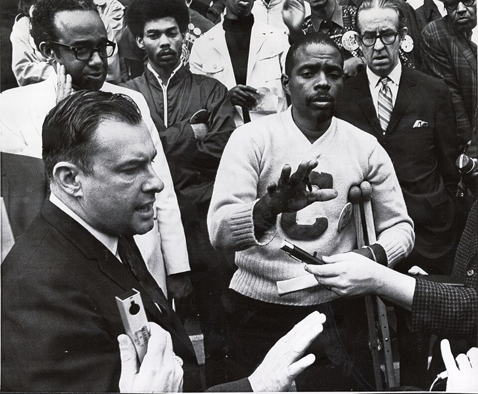 Ohio House Speaker Charles Kurfess, left, and Leonard Tate, center, hold up their hands after Kurfess made a statement to demands made by Tate on the steps of the state Capitol in Columbus. Tate, leading a large group of mostly Black demonstrators, presented four demands by the student body of Central State University, 1969.